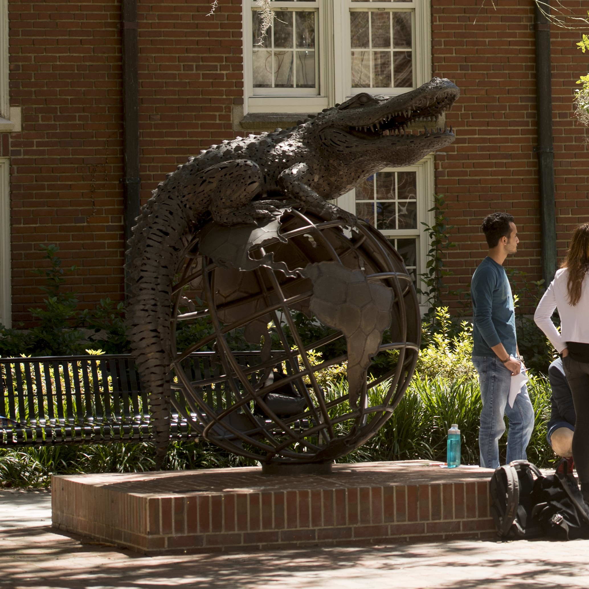 Photograph of statue of a gator sitting on a globe, photographed by Timothy Sofranko