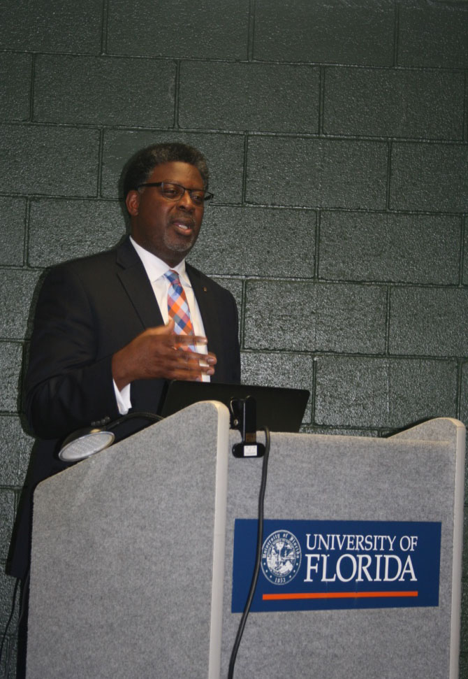 Photo of lecturer giving a presentation to an audience at the University of Florida